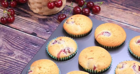 Cherry muffins on wooden background Stock Footage 163431455