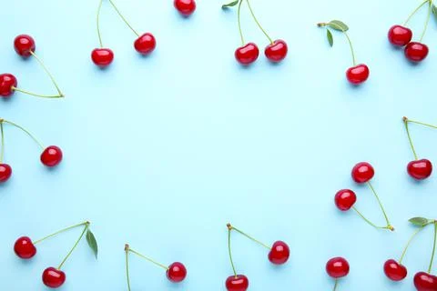 Cherry pattern. Flat lay of cherries on a blue background with copy space.Top Foto stock