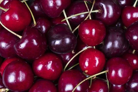 Cherry pattern. Sweet cherries background texture. Ripe sweet red cherries... Stock Photos