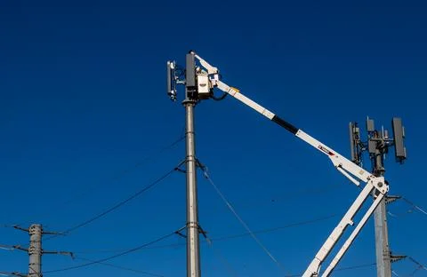 Cherry picker crane installing Cell Tower Stock Photos