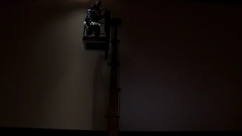 Cherry picker going up to fix lighting rig Stock Footage 98681757