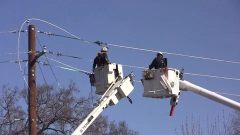 Cherry PIcker Utility Workers -one loops wire around pole Stock Footage 105138674