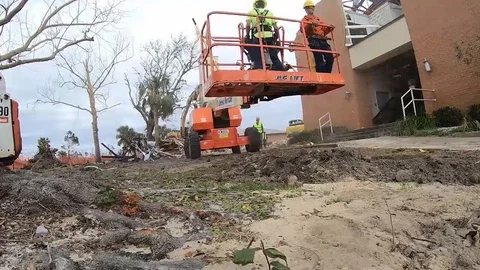 Cherry picker working on site of demolished chapel damaged by Hurricane Michael Stock Footage 103259194