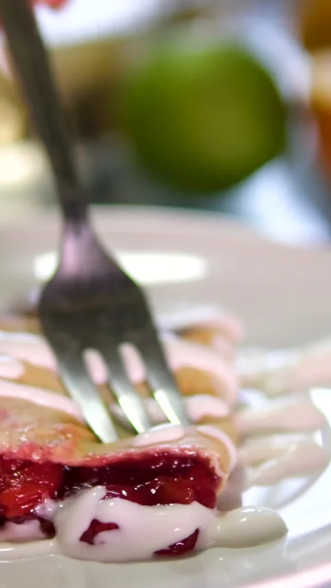 Cherry pie fork poke slice open lots of filling cherry strudel with sour cream Stock Footage 301740651