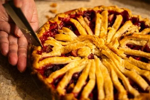 Cherry Pie Slice Being Cut with Flaky Crust Detail Stock Photos