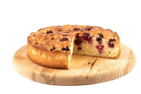 Cherry pie with triangular cut on a cutting board over white background. Stock-Fotos