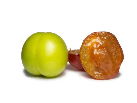 Cherry plum at different stages of maturation. Plum variety. Red and green fr Stock Photos