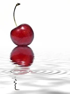 Cherry reflected on water. Stock Photos