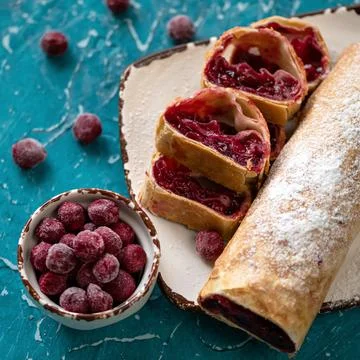 Cherry roll, pie or strudel. Gourmet dessert, sweet pastries stuffed with frozen Stock Photos