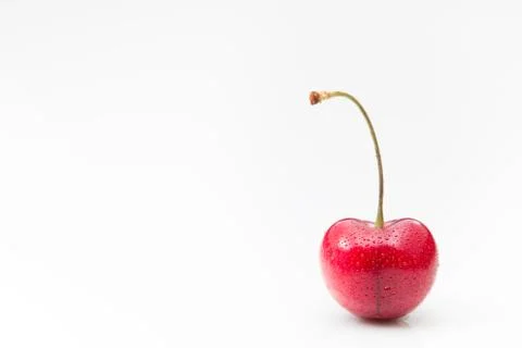 A cherry with stem on a white background. Stock Photos