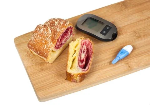 Cherry strudel and glucometer on a cutting board Stock Photos