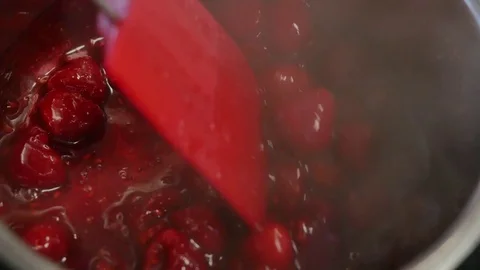 Cherry in syrup, boiled cherry. Boiling raspberry syrup. Preparation of Stock Footage