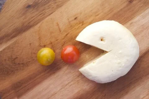 Cherry tomato, and cheese on table Stock Photos