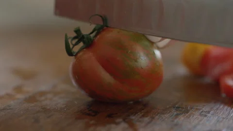 Cherry tomato being sliced close up macro Stock Footage 255817997