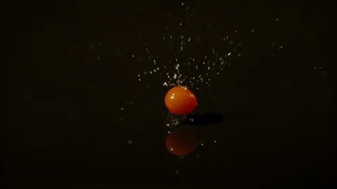 Cherry tomato falling on a wet surface, Ultra Slow Motion Stock Footage 86699484