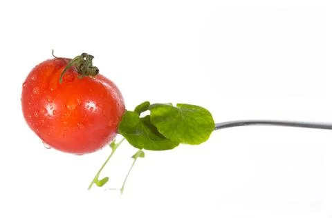 Cherry tomato on a fork Stock-Fotos