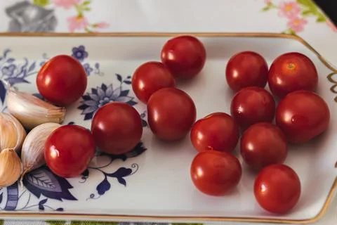 Cherry tomato with garlic on a table Foto stock