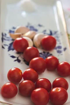 Cherry tomato with garlic on a table Stock-Fotos