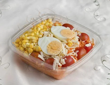 Cherry tomato, hard-boiled egg and corn kernels salad Stock Photos