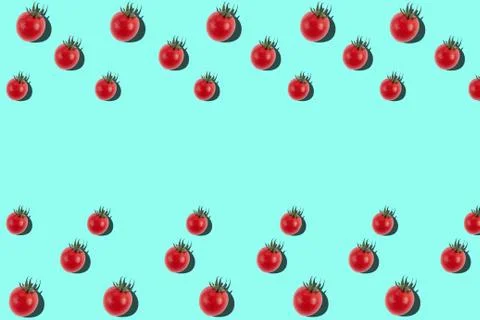 Cherry tomato pattern on light blue background. Stock Photos