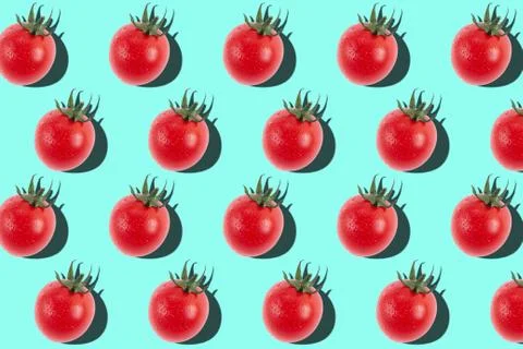 Cherry tomato pattern on light blue background. Stock Photos