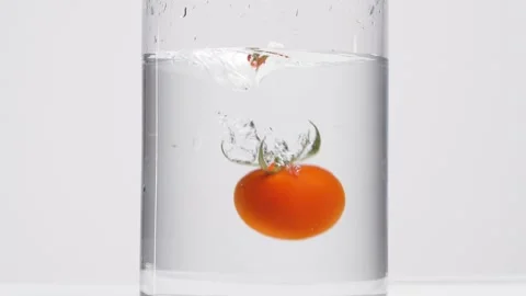 A cherry tomato in the water Stock Footage 132861281