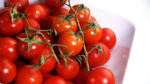 Cherry tomato on a white background seen close up with rotating view Stock Footage 92447236