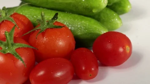 Cherry tomatoes and cucumbers on a white background Stock Footage 71333843
