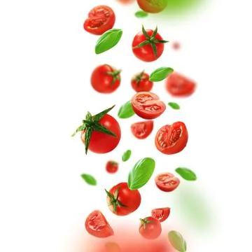 Cherry tomatoes and leaves falling from the air Stock Photos