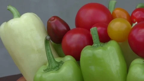 Cherry tomatoes and peppers in bowl. Fresh seasonal vegetables concept Stock Footage
