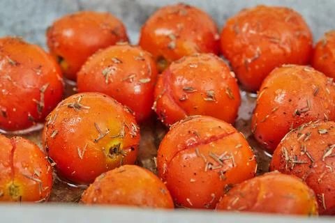 Cherry tomatoes are ready after baking in the oven for appetizer with ricot.. Stock Photos
