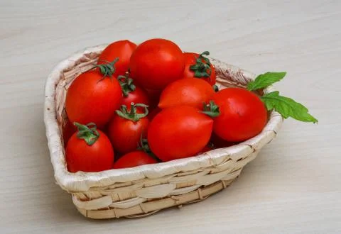 Cherry tomatoes in the basket Stock Photos