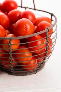 Cherry tomatoes in basket Stock Photos