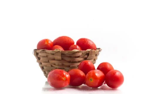 Cherry Tomatoes into a basket Stock Photos