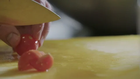 Cherry tomatoes being cut in two - slow motion Stock Footage 129016248
