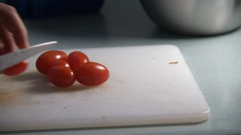 Cherry Tomatoes being sliced in slow motion. Stock Footage 128688265