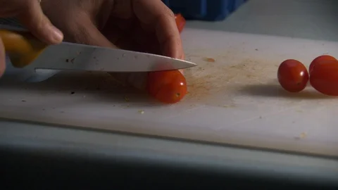 Cherry Tomatoes being sliced in slow motion. Stock Footage 128688317