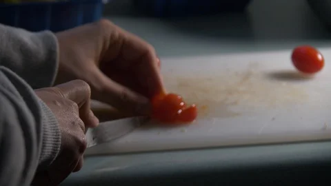 Cherry Tomatoes being sliced in slow motion. Stock Footage 128688403