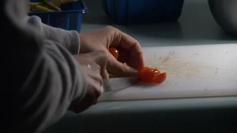 Cherry Tomatoes being sliced in slow motion. Stock Footage 128688589