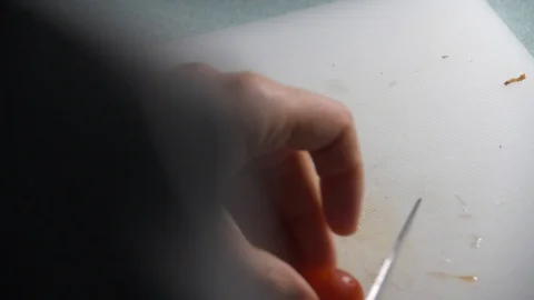 Cherry Tomatoes being sliced in slow motion. Stock Footage 128688699