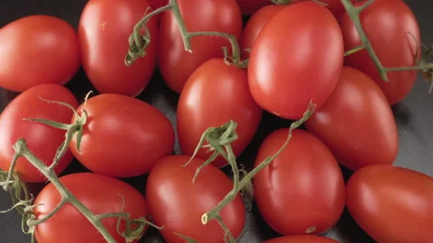 Cherry tomatoes on a black background close up 스톡 동영상 137443027