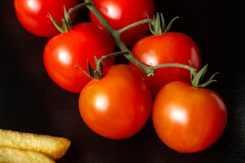 Cherry tomatoes on a black background. 스톡 사진