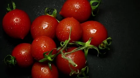 Cherry Tomatoes on Black Bckground Stock Footage 63618354