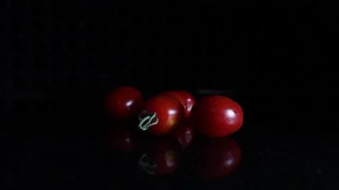 Cherry Tomatoes on black Surface Video stock 157809040