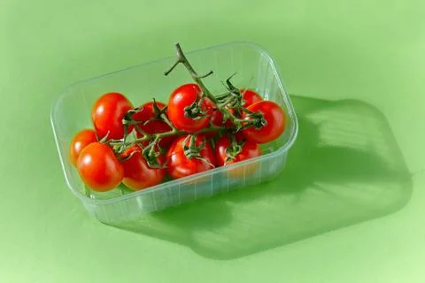 Cherry tomatoes bowl on a table. Stock Photos