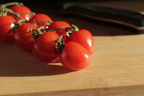 Cherry tomatoes on a branch Stock Photos