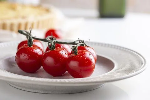 Cherry tomatoes on a ceramic plate Stock Photos