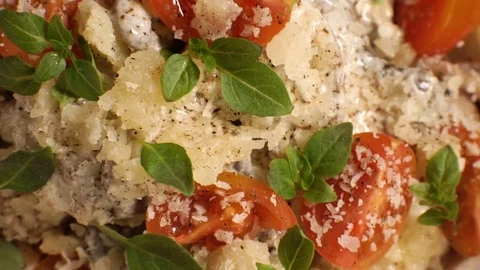 Cherry tomatoes, cheese and basil on pasta. Video Stock Footage 85331208