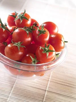Cherry tomatoes in a clear container Stock Photos