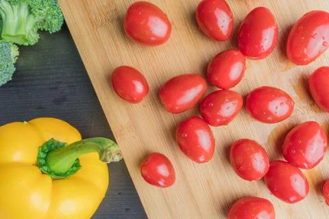 Cherry tomatoes on a cutting board Stock Photos